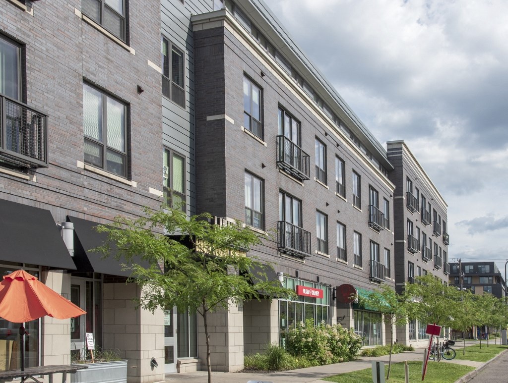 a large brick building with a red umbrella in front of it