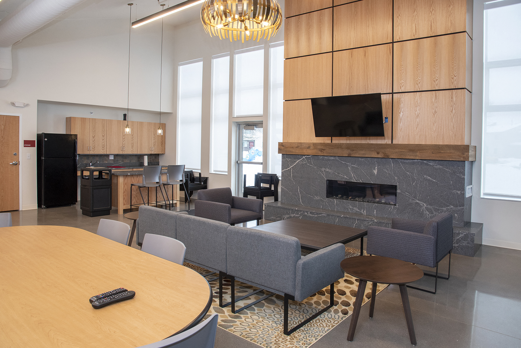 a living room with a table and chairs and a fireplace