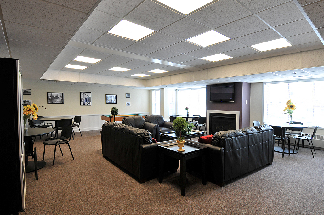 a living room with couches and a table and chairs