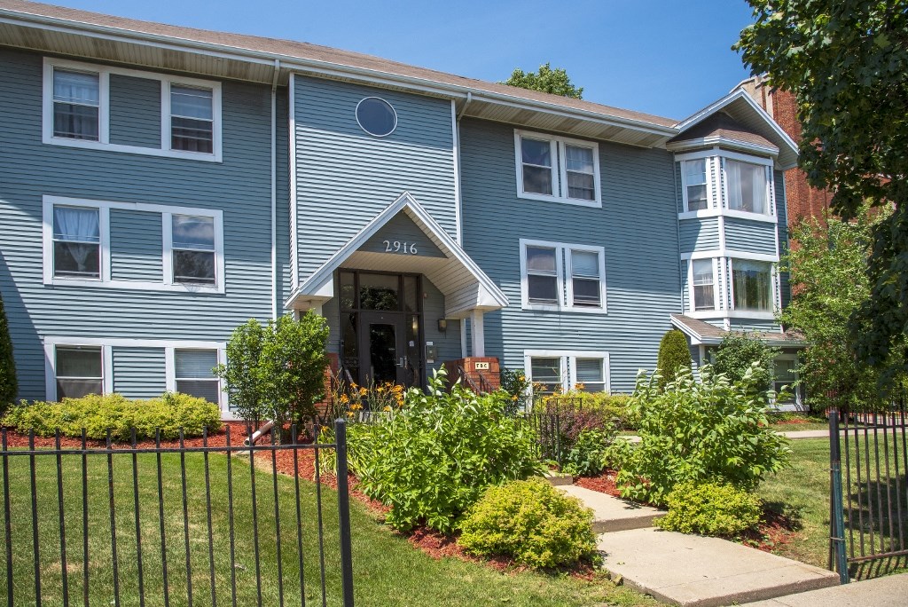 a blue house with a garden in front of it