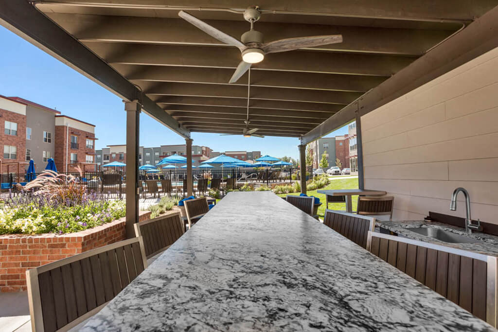 Westlake Greens Outdoor Kitchen grey granite countertop with sink and outdoor ceiling fan