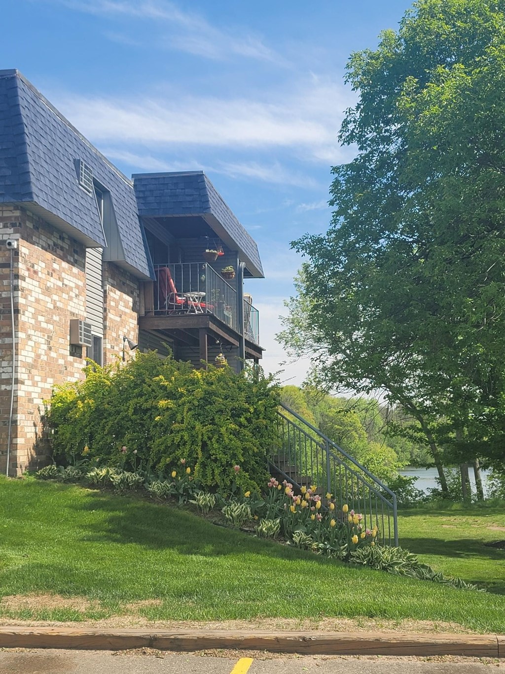 the back of a house with a yard and a balcony
