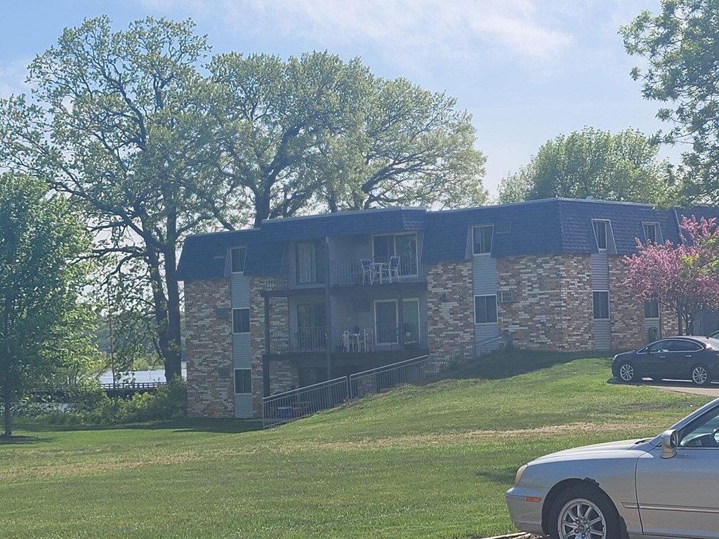 a house on a hill with cars parked in front of it