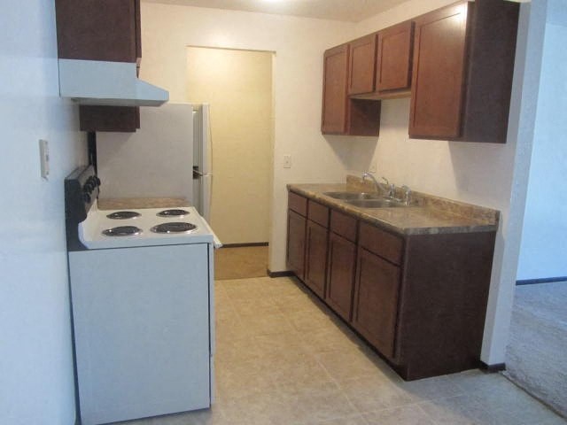 a small kitchen with a stove and a sink