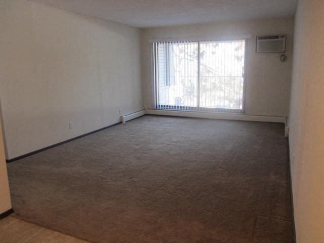 an empty living room with a large window