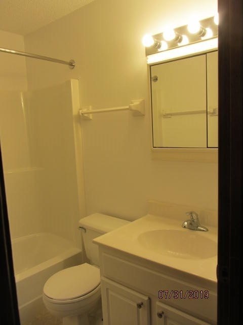 a white bathroom with a toilet and a sink