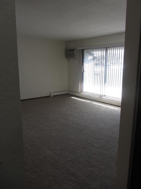 an empty living room with a large window