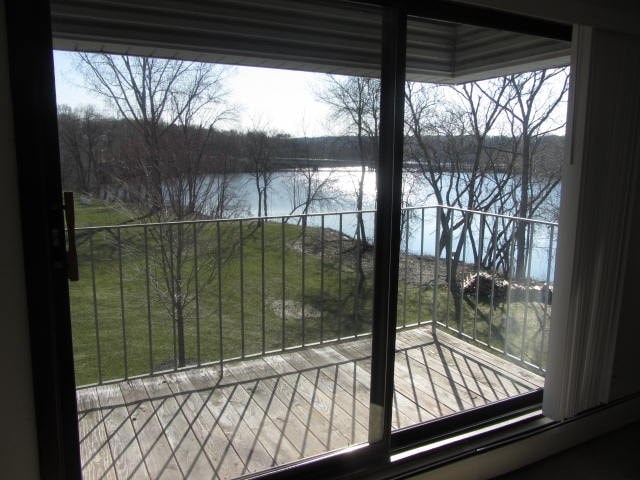 a view of a balcony overlooking a lake from a window