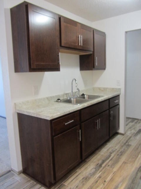 a kitchen with a sink and wooden cabinets