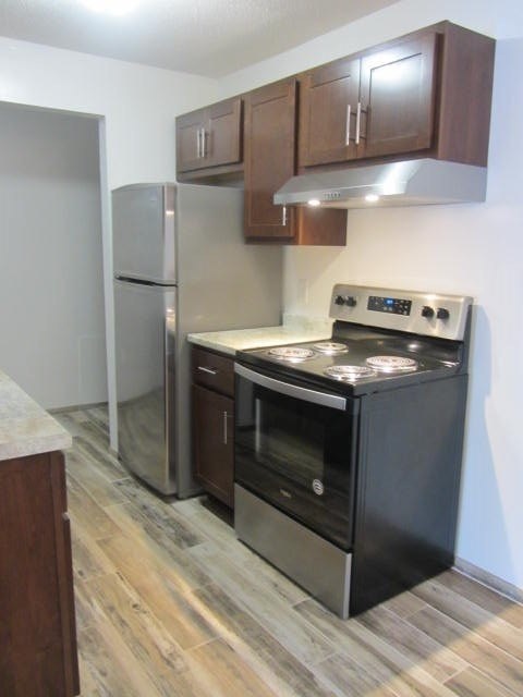 a kitchen with a stove and a refrigerator