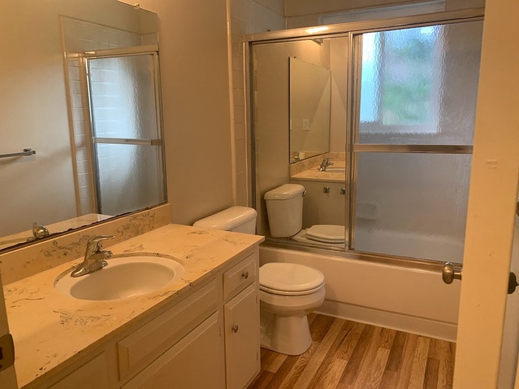 a bathroom with a sink toilet and a mirror