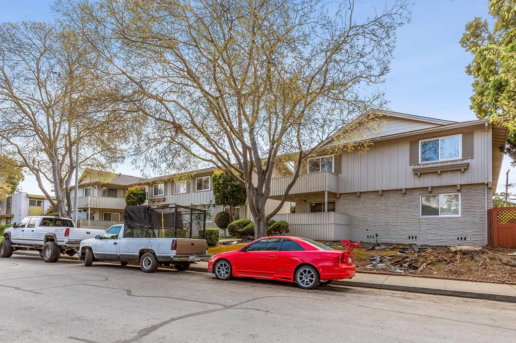 a red car parked in front of a house