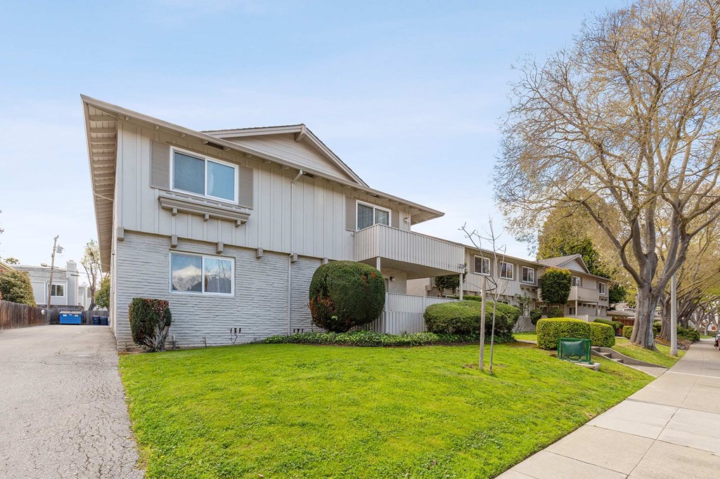 a white house with a yard and a sidewalk