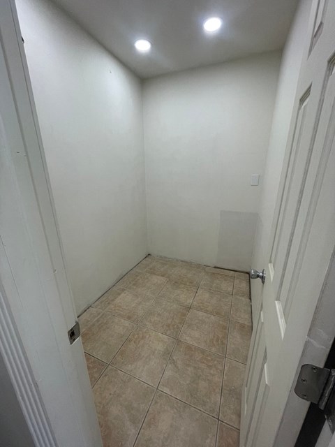 a white room with a tiled floor and white walls