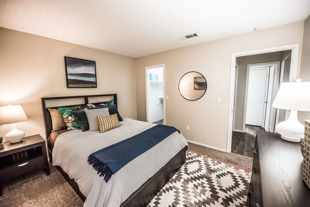 a bedroom with a bed and a door to a bathroom