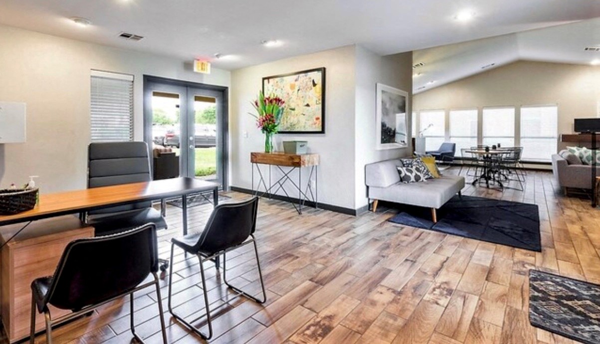 a living room with a couch and a table with chairs