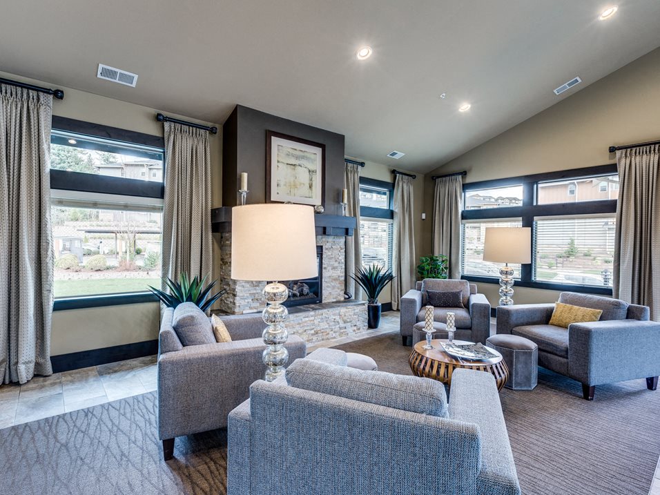 a living room with couches and chairs and a fireplace