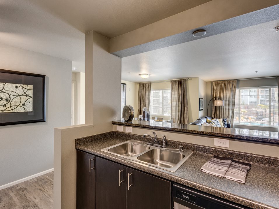 Kitchen with sink and view of living area