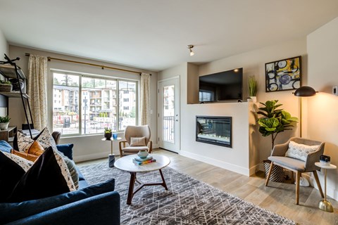 a living room with a couch and a chair and a fireplace