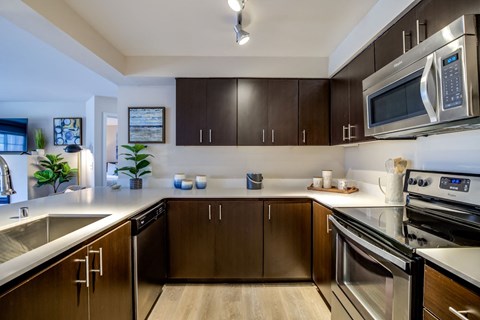 a modern kitchen with stainless steel appliances and wooden cabinets