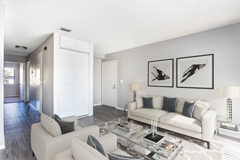 A living room with a white couch and a coffee table.