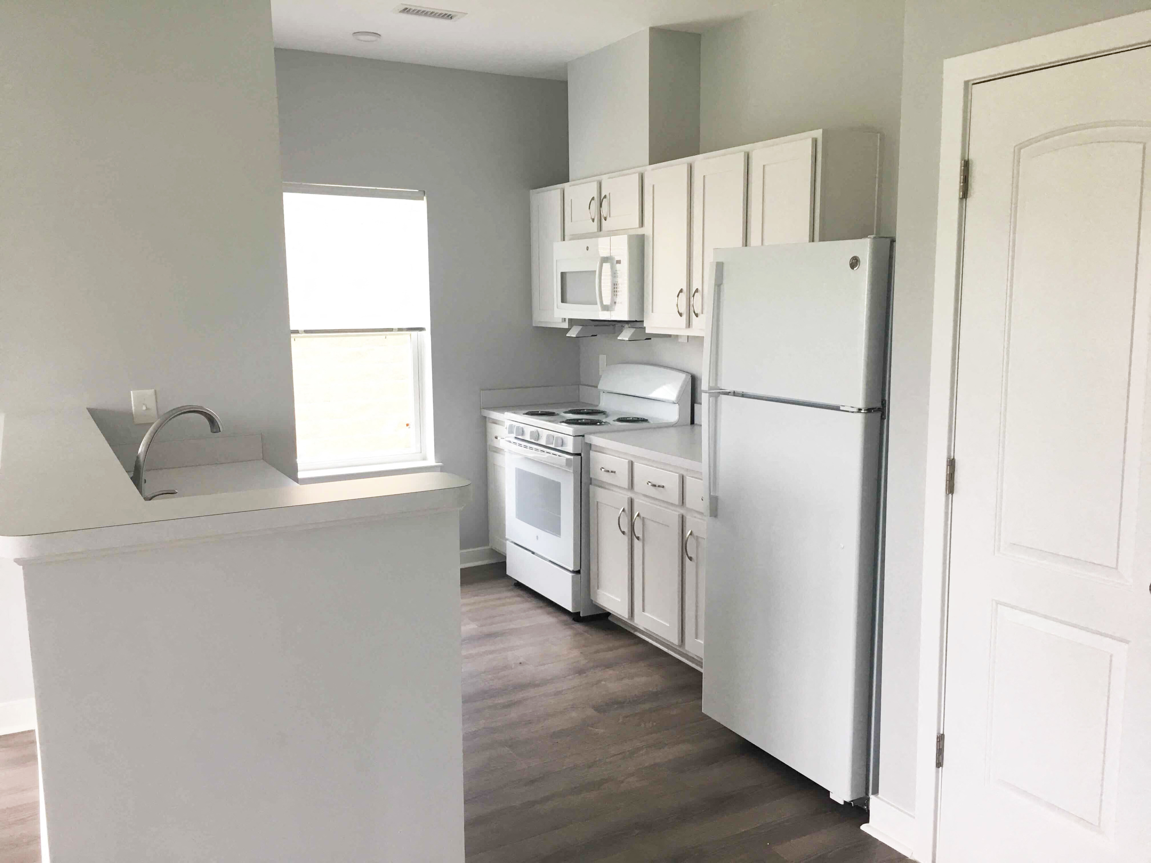 Kitchen with refrigerator, oven and sink