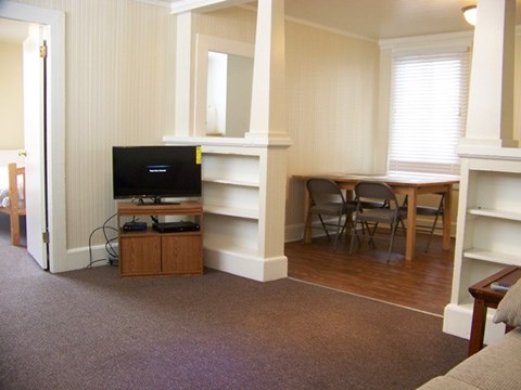 A living room with a television and a chair.