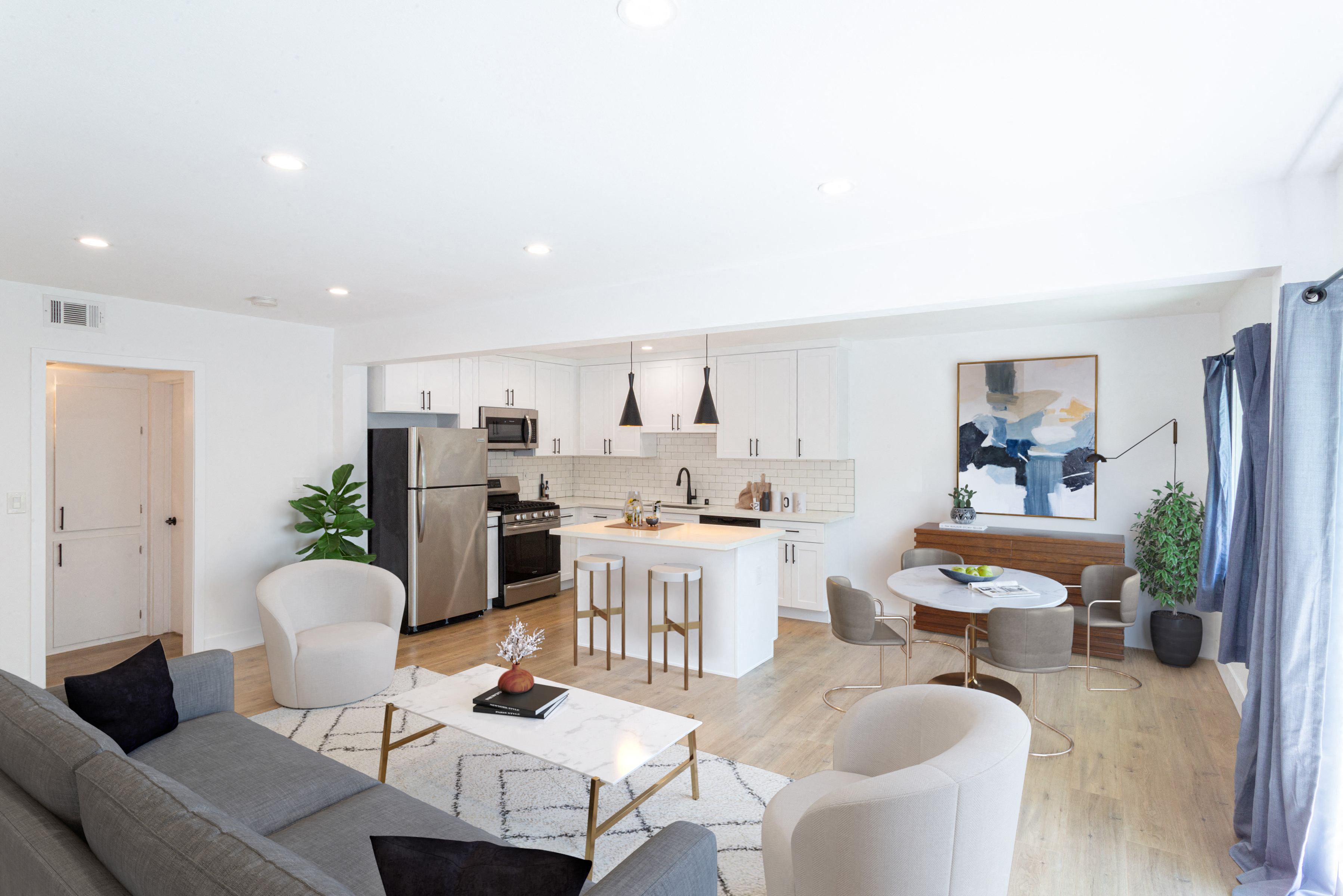 Open floor plan with living area, dining area, and kitchen