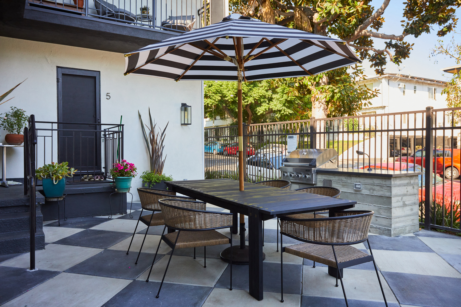 Outdoor lounge space with BBQ grill and outdoor dining