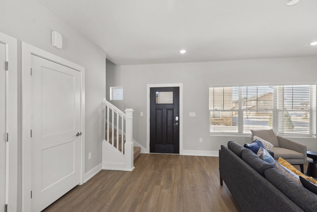 a living room with a couch and a door to a hallway