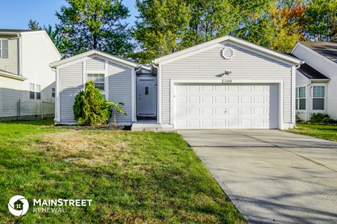 a white house with a white garage door and a driveway