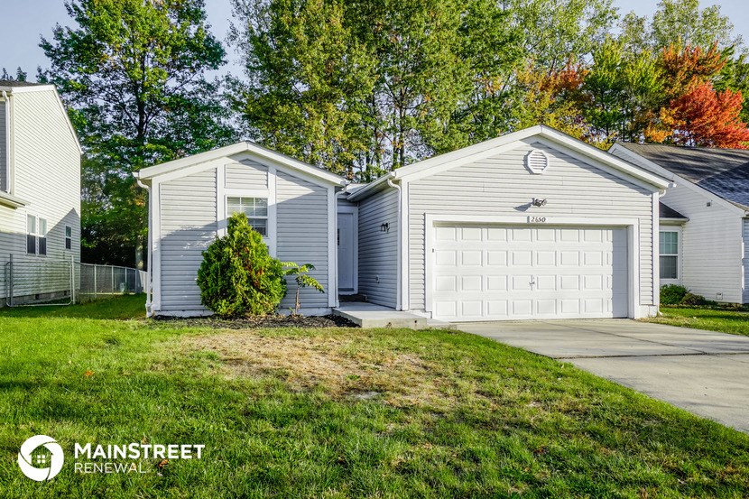 a white and gray garage with a white garage door