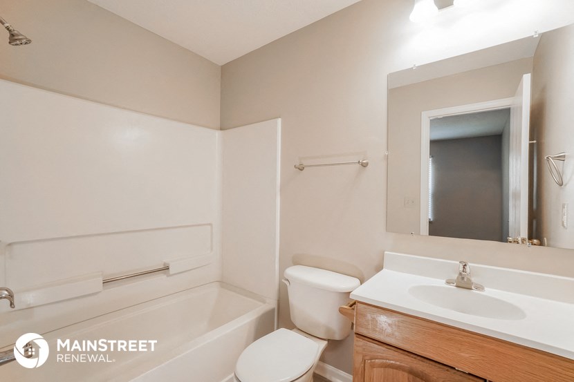 a bathroom with a toilet and a sink and a bath tub