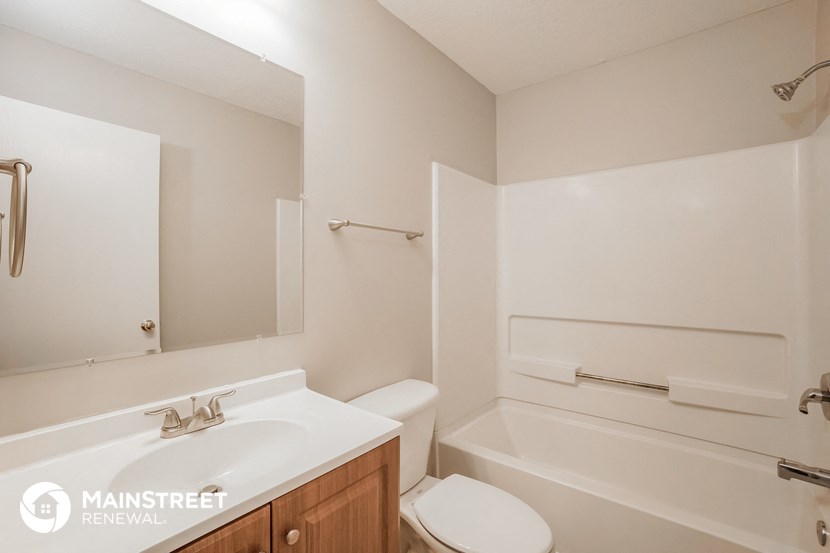 a bathroom with a sink and a toilet and a bath tub