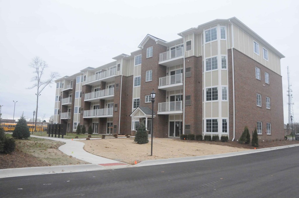 an exterior view of an apartment building on a city street