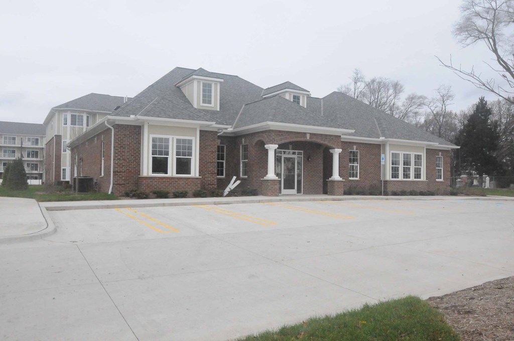 a large brick house with a driveway in front of it