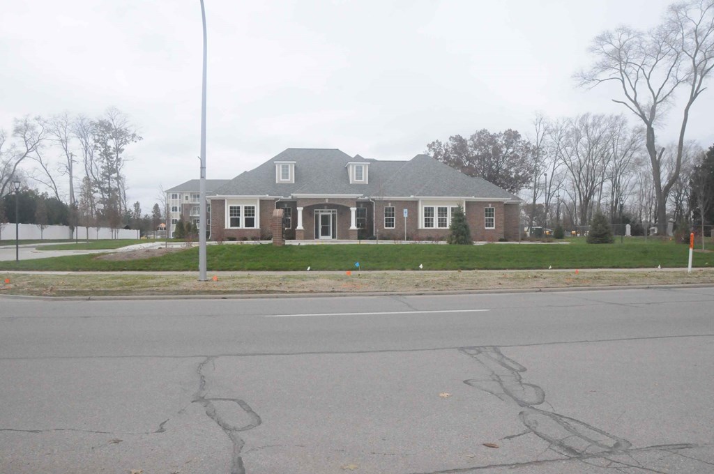 a large brick house on the corner of a street