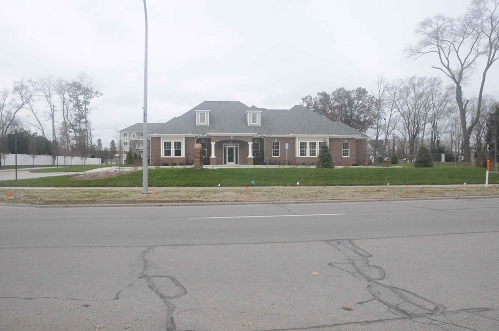 a large brick house on the corner of a street