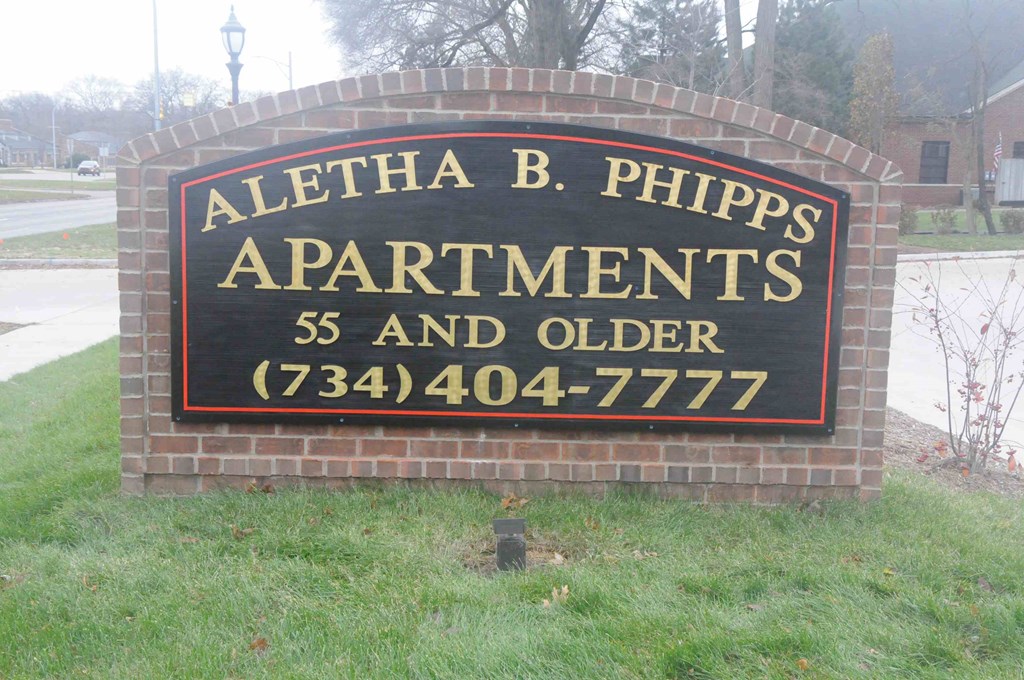 a sign in front of a building that says apartments 55