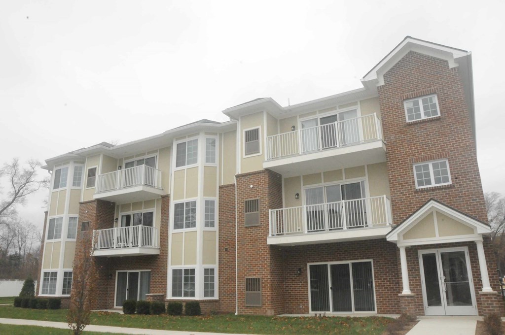 an exterior view of an apartment building on a rainy day