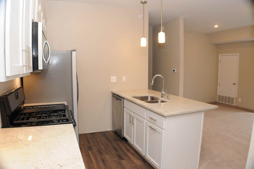 a kitchen with a sink and a refrigerator
