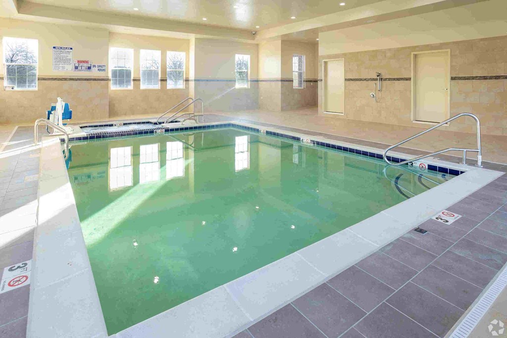 a swimming pool with green water in a large room