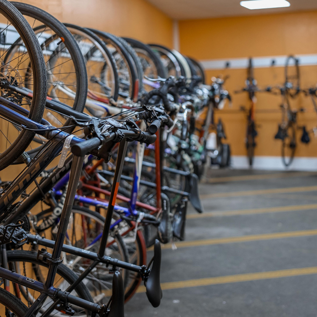 a row of bikes parked in a storage room