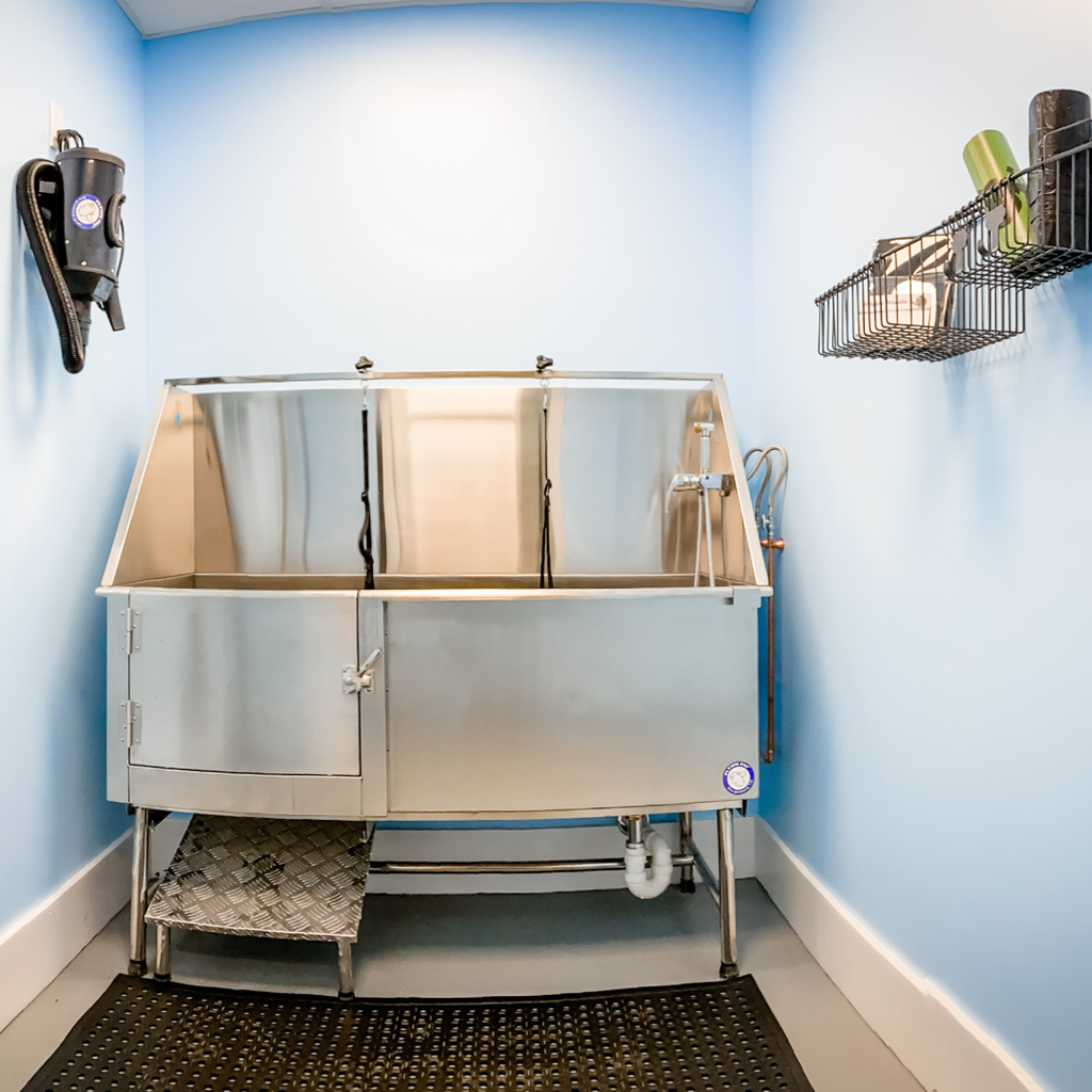 a stainless steel sink in a room with two baskets on the wall
