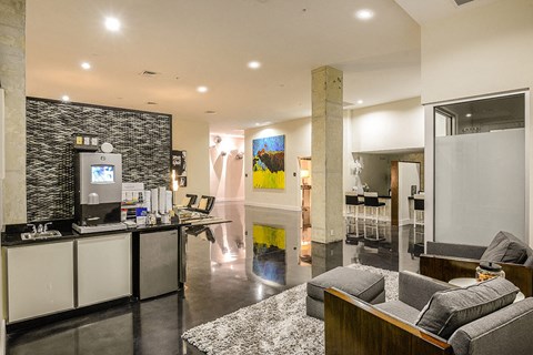 a living room with a couch and a bar and a kitchen