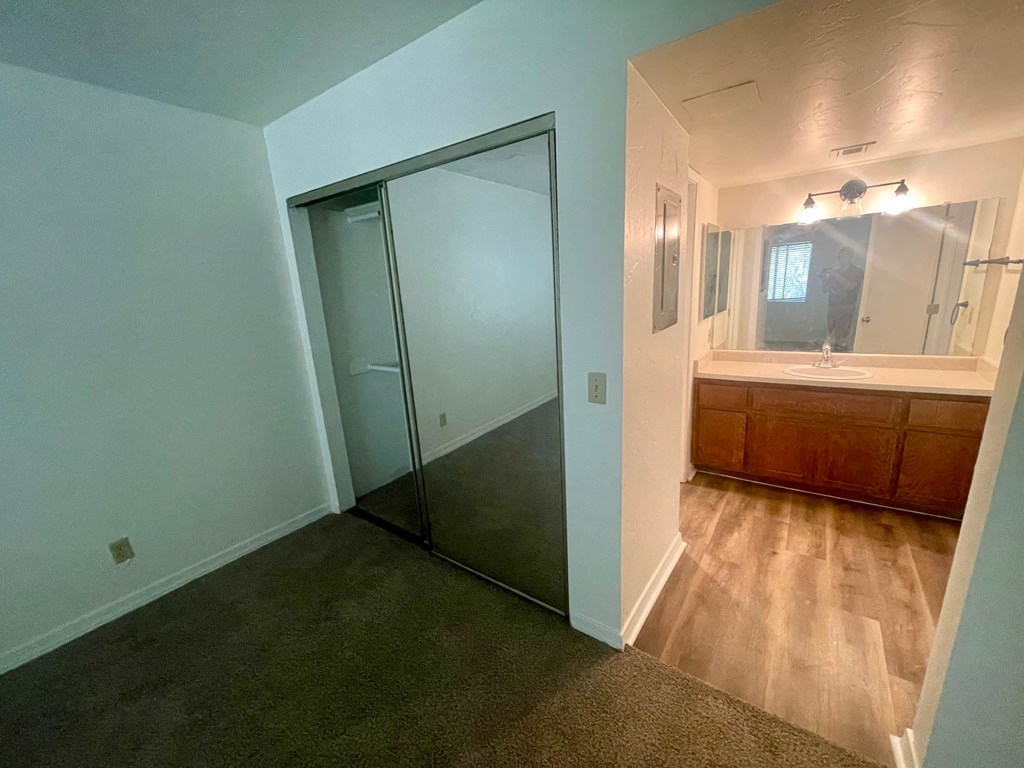 a bathroom with a sink and a mirror and a sliding glass door