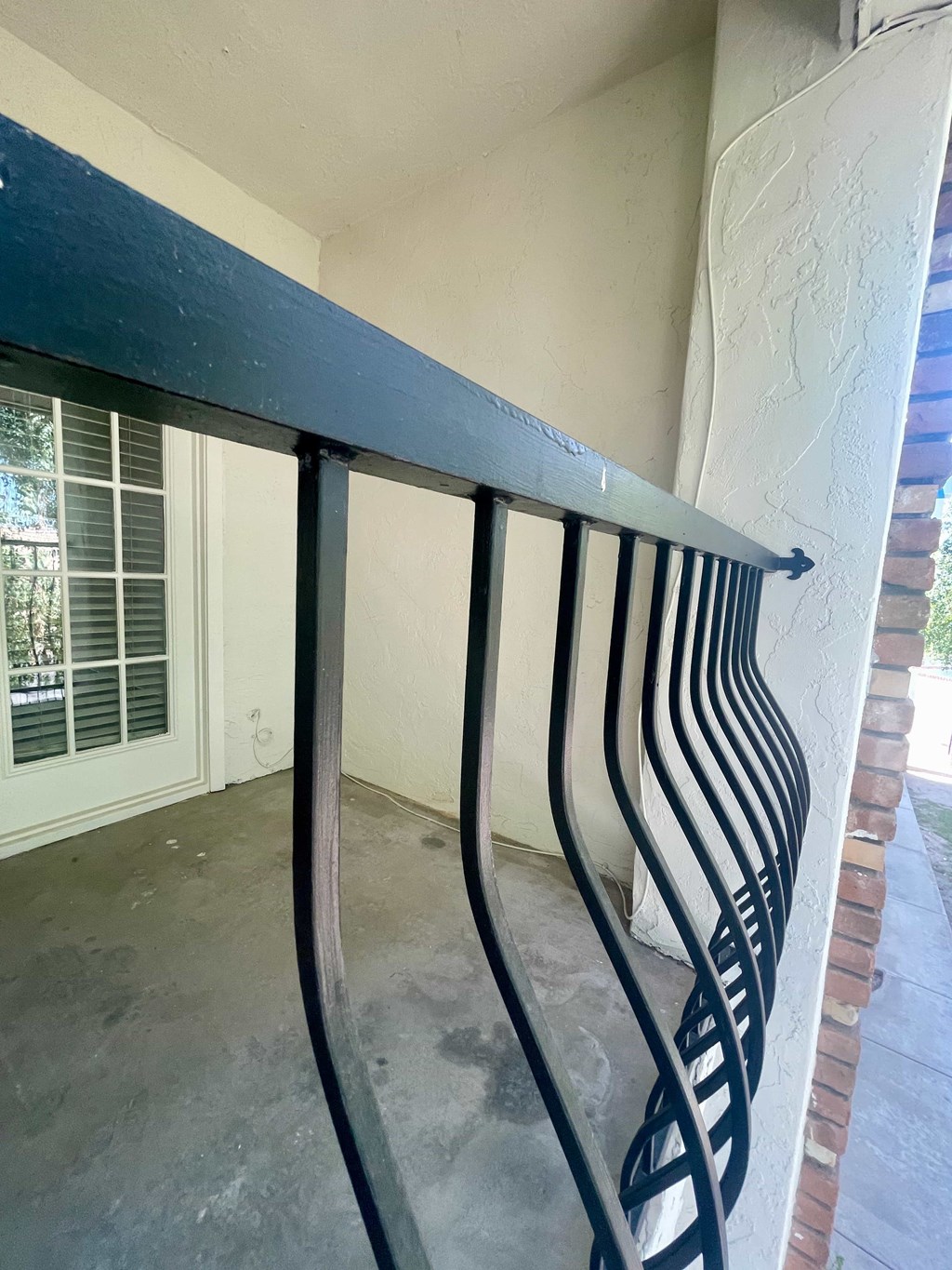 a metal railing with a blue counter top on a balcony