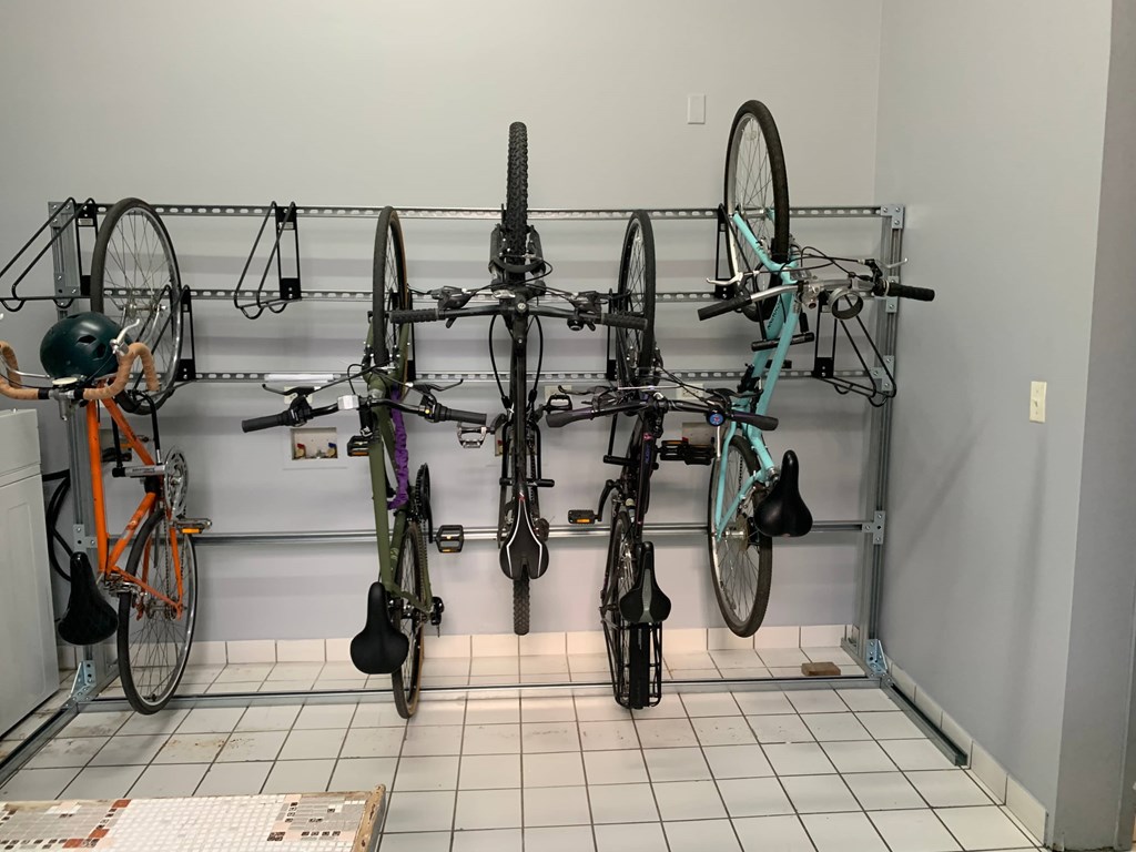 a wall mounted bike rack with several bikes on it