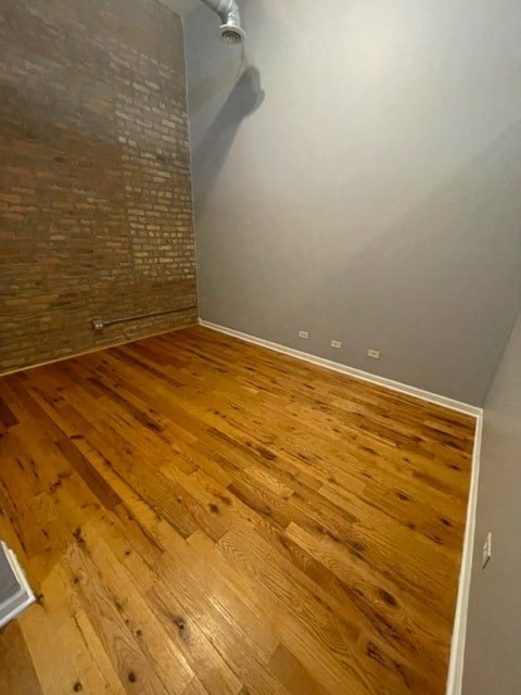 a room with a hard wood floor and a white wall