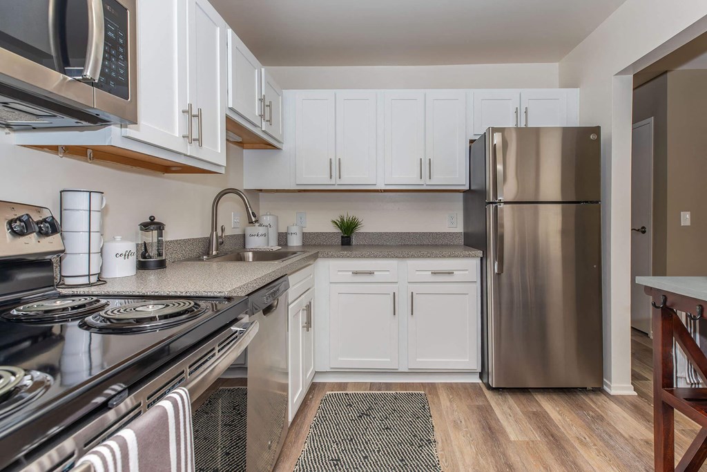 a kitchen with stainless steel appliances and white cabinets